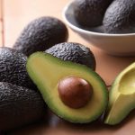 Strong avocado market expected to continue - cut avocado in bowl on table